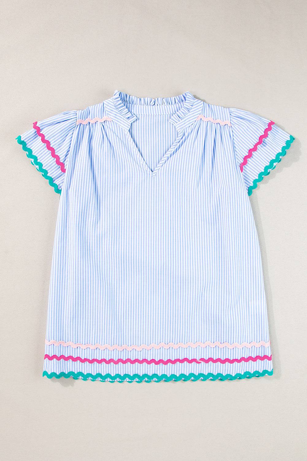 a blue and white striped shirt with pink trim