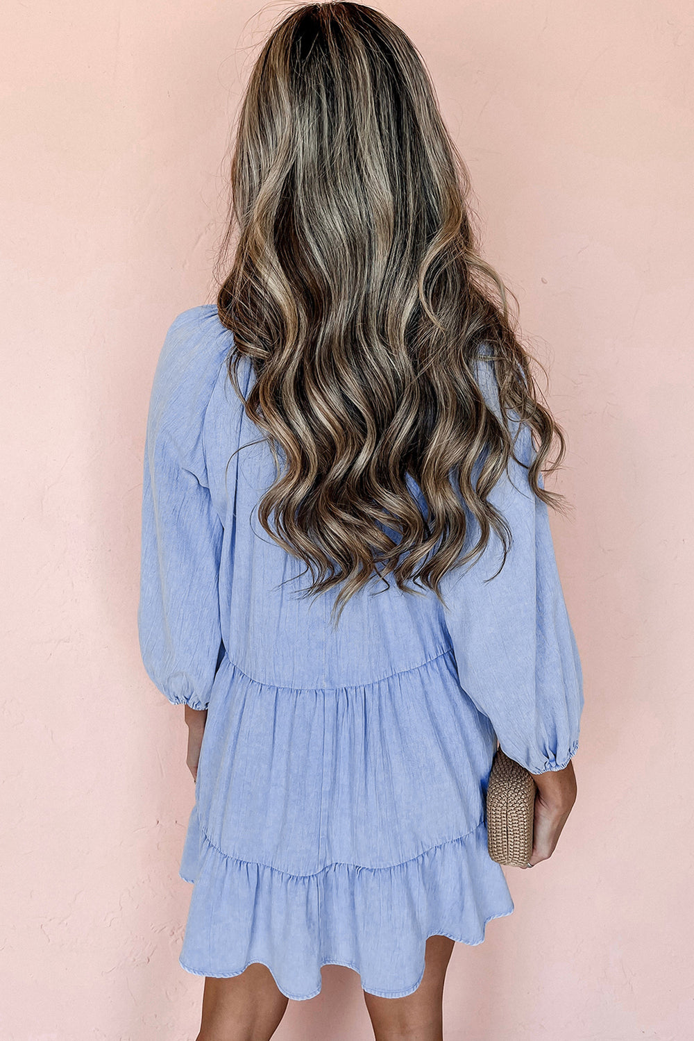 Back view of Light Blue Puff Sleeve V Neck Tiered Ruffled Chambray Mini Dress, highlighting tiered layers and relaxed silhouette.