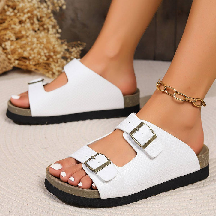 a close up of a person wearing white sandals