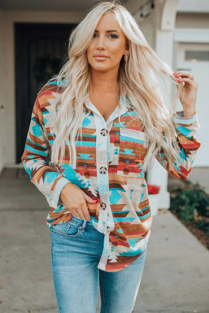 a woman wearing a colorful shirt and jeans