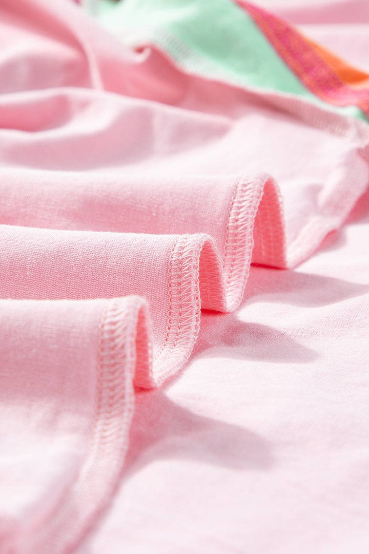 a close up of a pink shirt with a green stripe