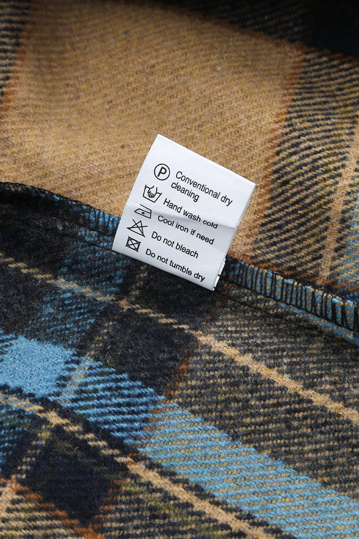 a label on the back of a plaid jacket