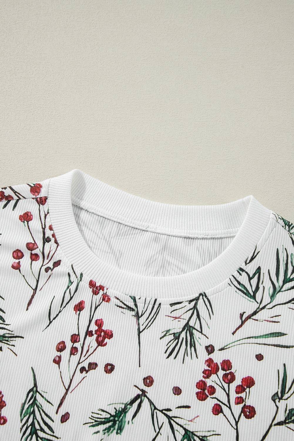 a white t - shirt with red berries on it