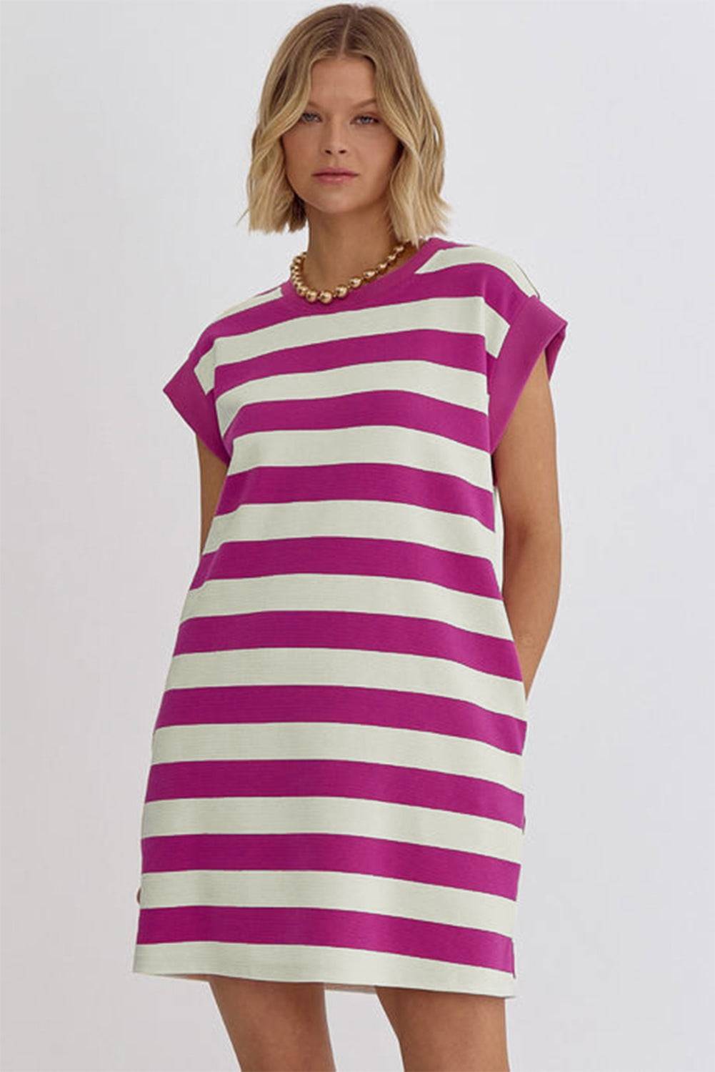 a woman in a purple and white striped dress