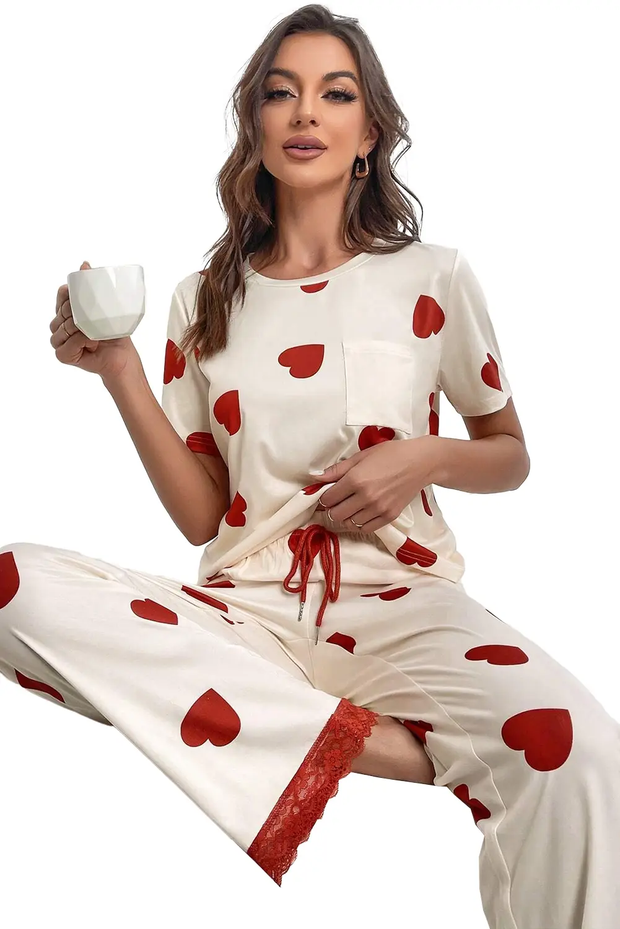 a woman sitting on the ground holding a cup of coffee