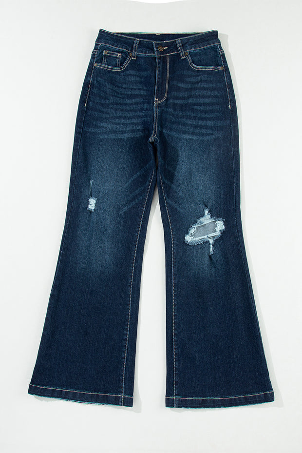 a pair of blue jeans with holes on them
