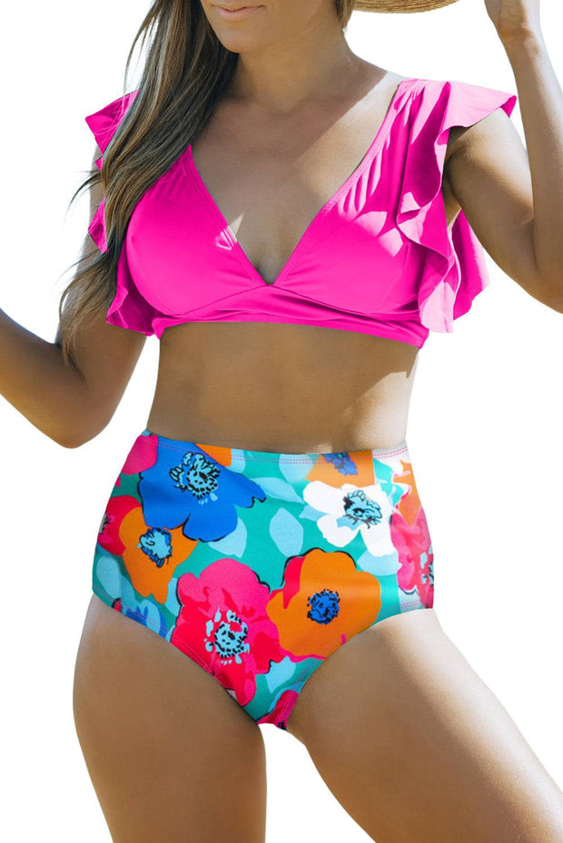 a woman in a bikini top and flower print shorts