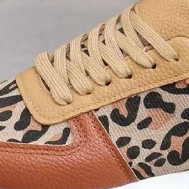 a pair of sneakers with a leopard print on the side