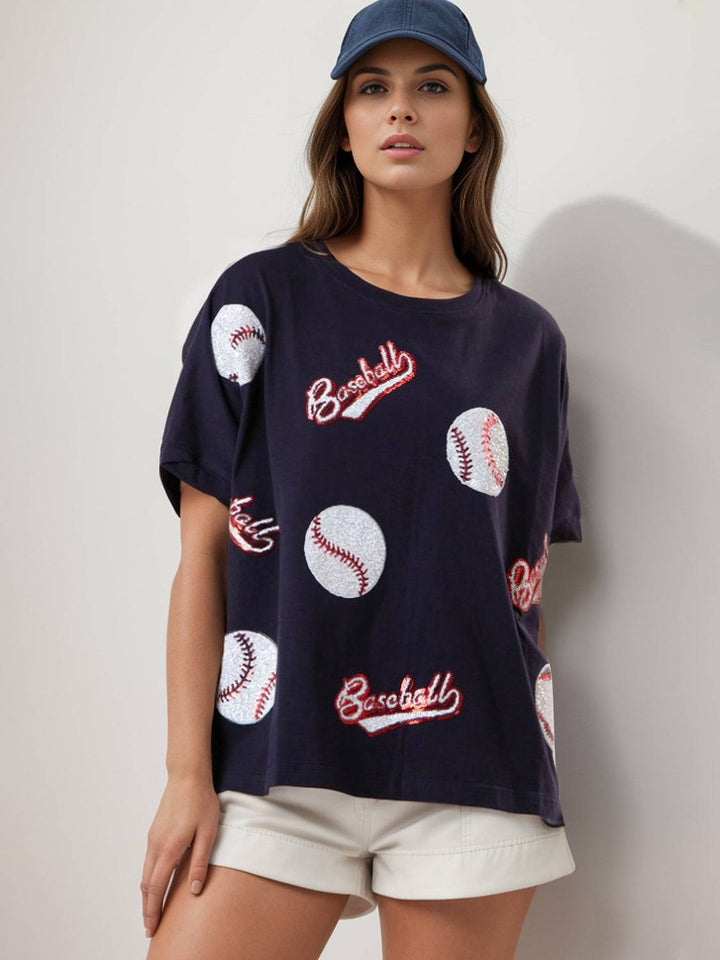 a woman wearing a baseball t - shirt and shorts