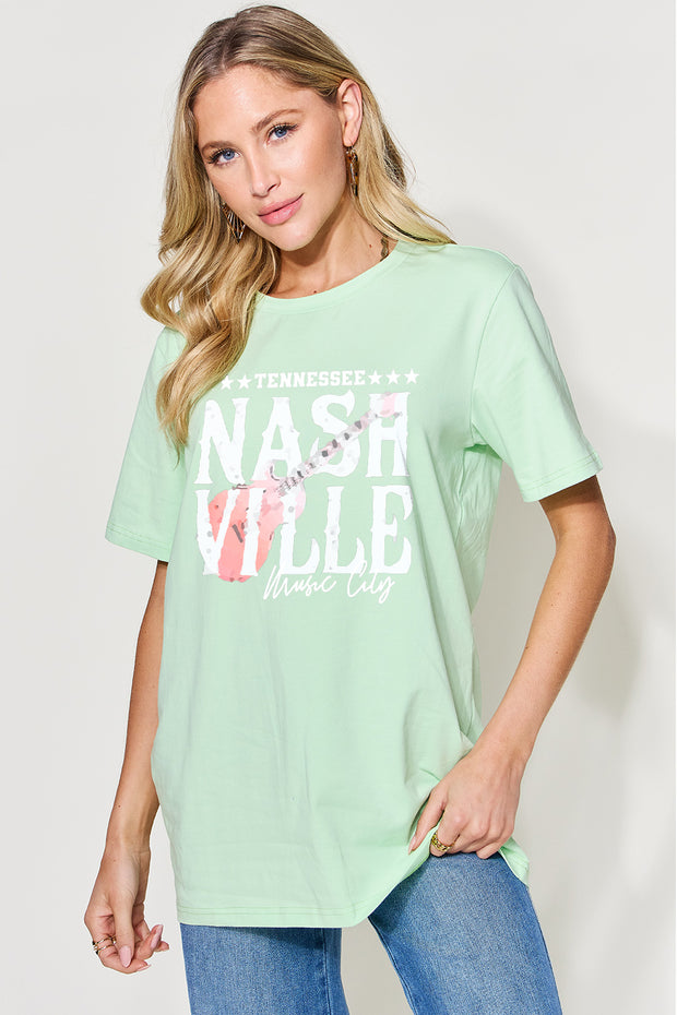 a woman wearing a mint green t - shirt with the words nashville wild on it