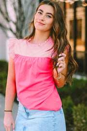 a woman in a pink top is posing for a picture