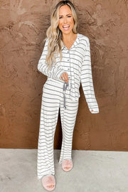 a woman wearing a white and black striped pajama set