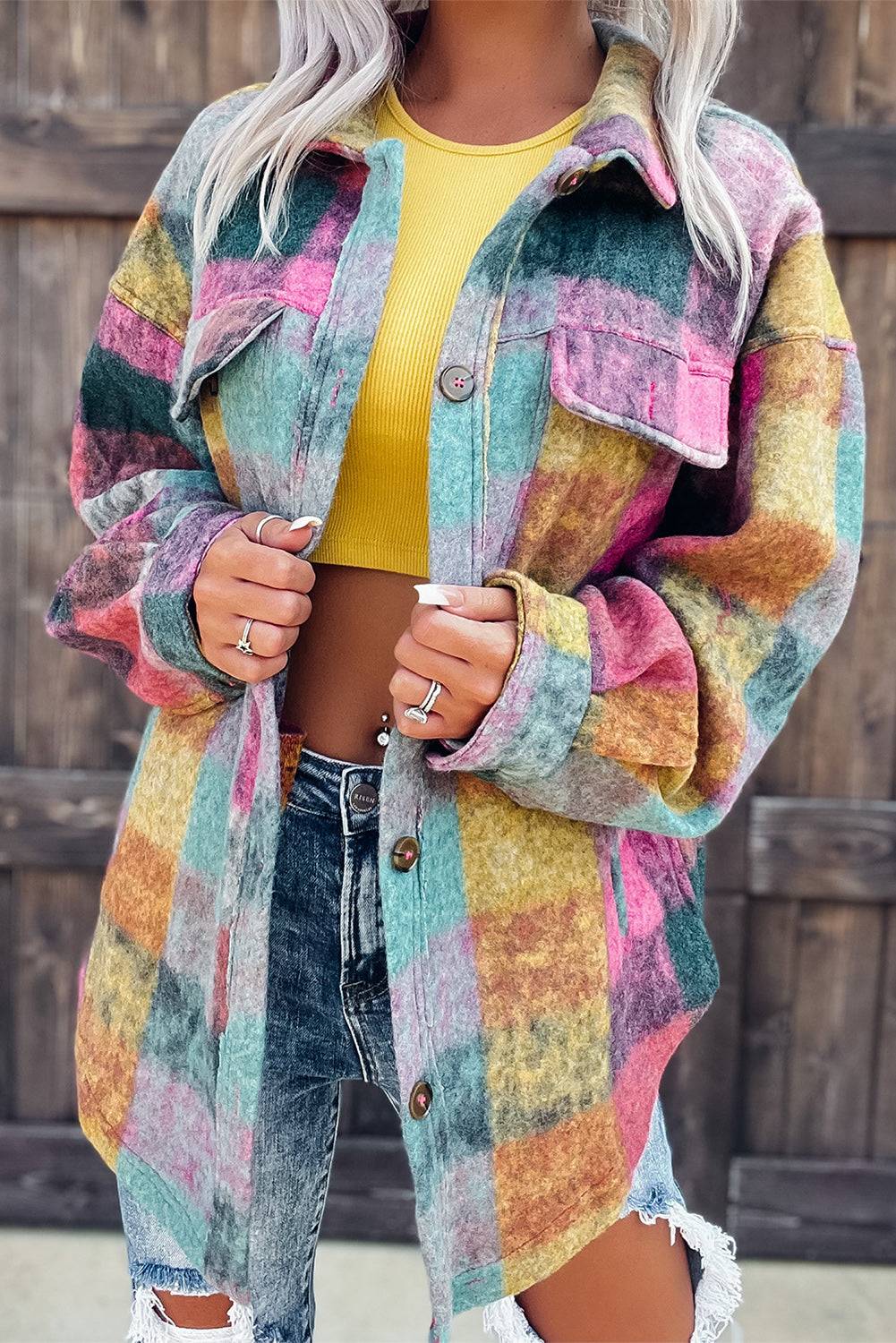 a woman wearing a colorful jacket and ripped jeans