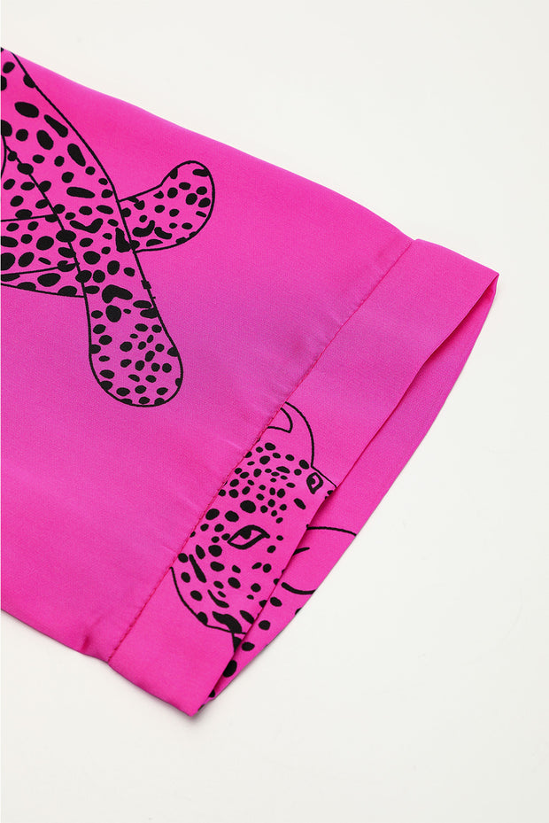 a pink bandana with a black and white leopard on it