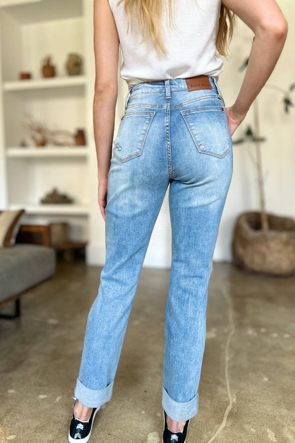 a woman in a white shirt and jeans