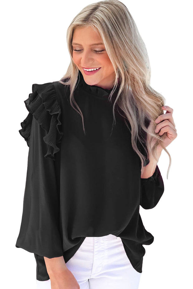 a woman wearing a black top with ruffled sleeves