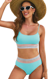 a woman in a blue bikinisuit and straw hat