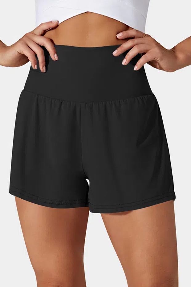 a woman in black shorts with her hands on her hips