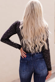 a woman with long blonde hair is standing with her hands on her hips