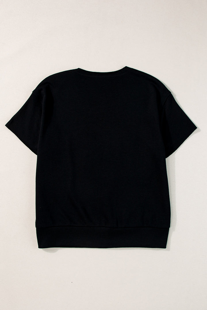 a black t - shirt hanging on a white wall