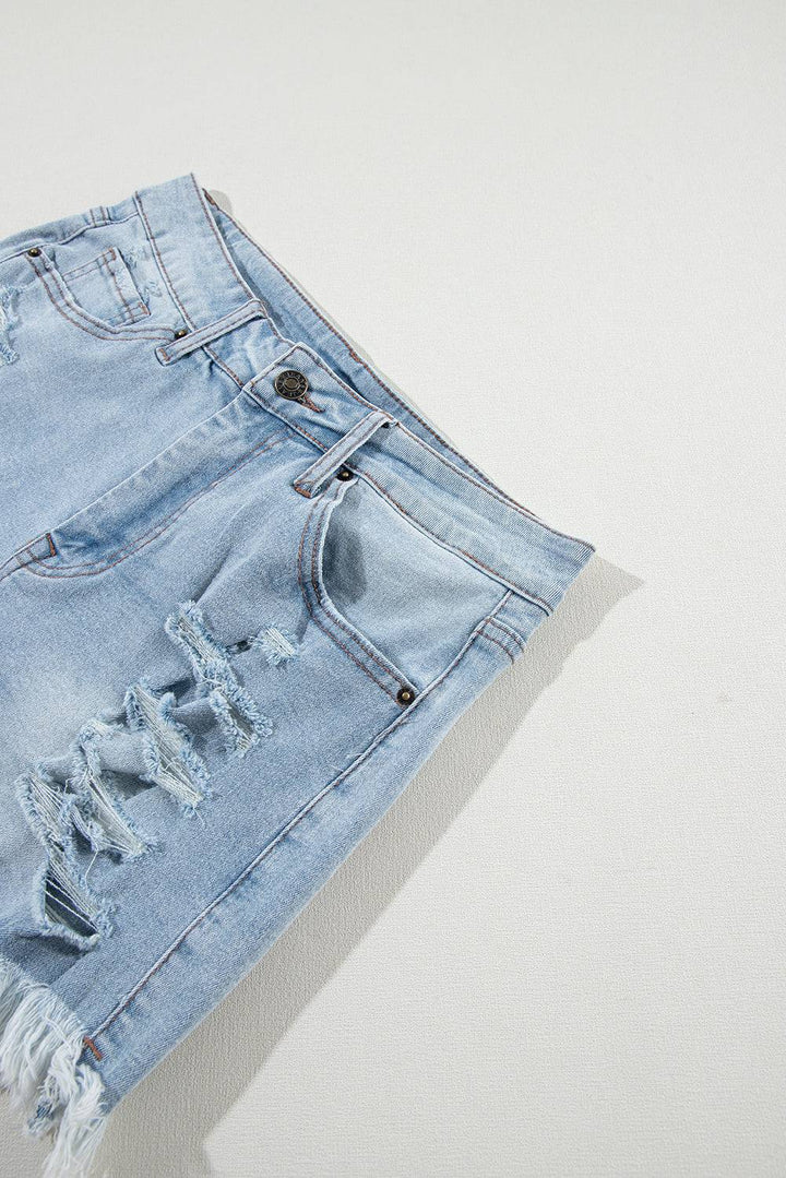 a pair of blue jean shorts with holes