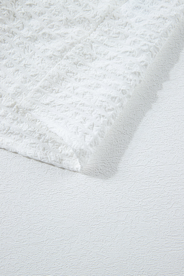 a close up of a white rug on a bed