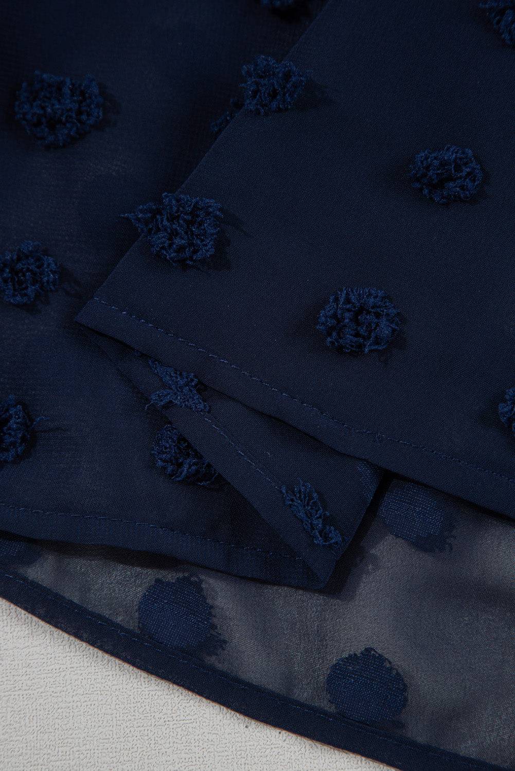 Close-up of hemline on Navy Blue Dotty Textured Notched Neck Plus Ruffled Dress, highlighting sheer Swiss dot fabric texture.