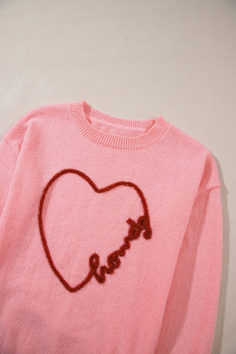 a pink sweater with a heart drawn on it