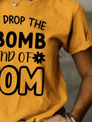 a woman wearing a t - shirt that says drop the bomb and end of mom