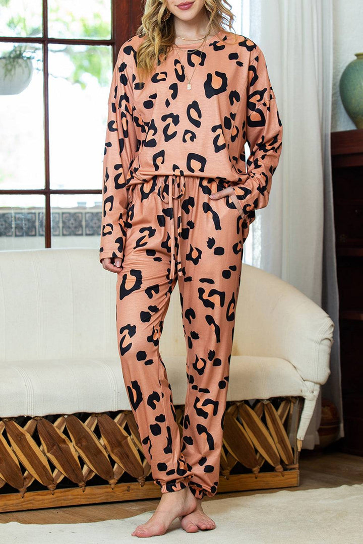 a woman wearing a pink and black leopard print pajamas