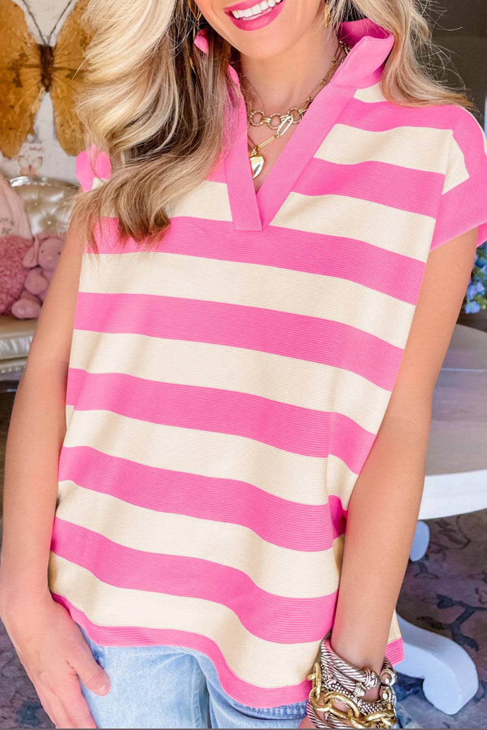 a woman wearing a pink and white striped top