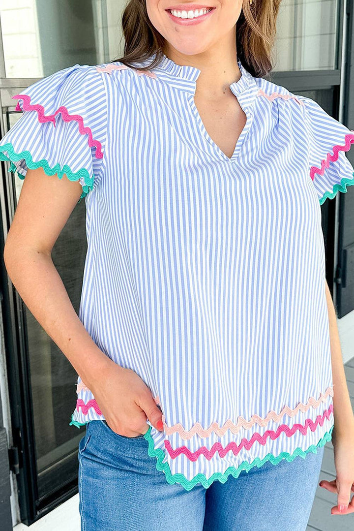 a woman wearing a blue and white striped top