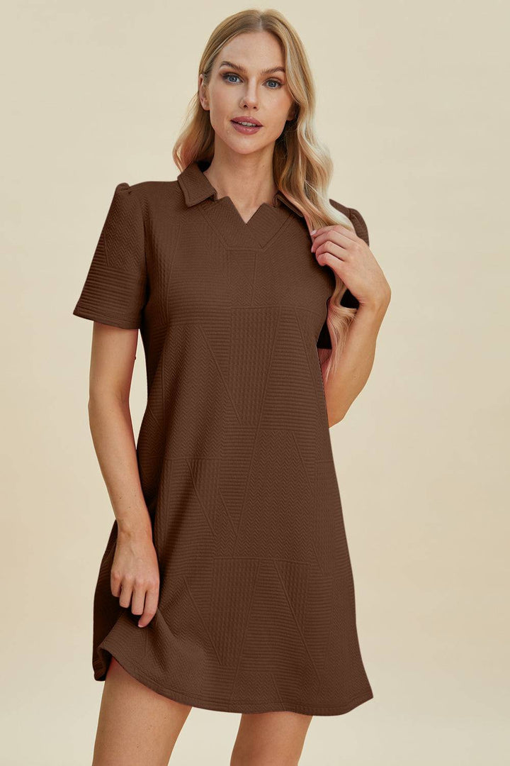 a woman wearing a brown shirt dress