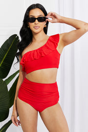a woman in a red one piece swimsuit