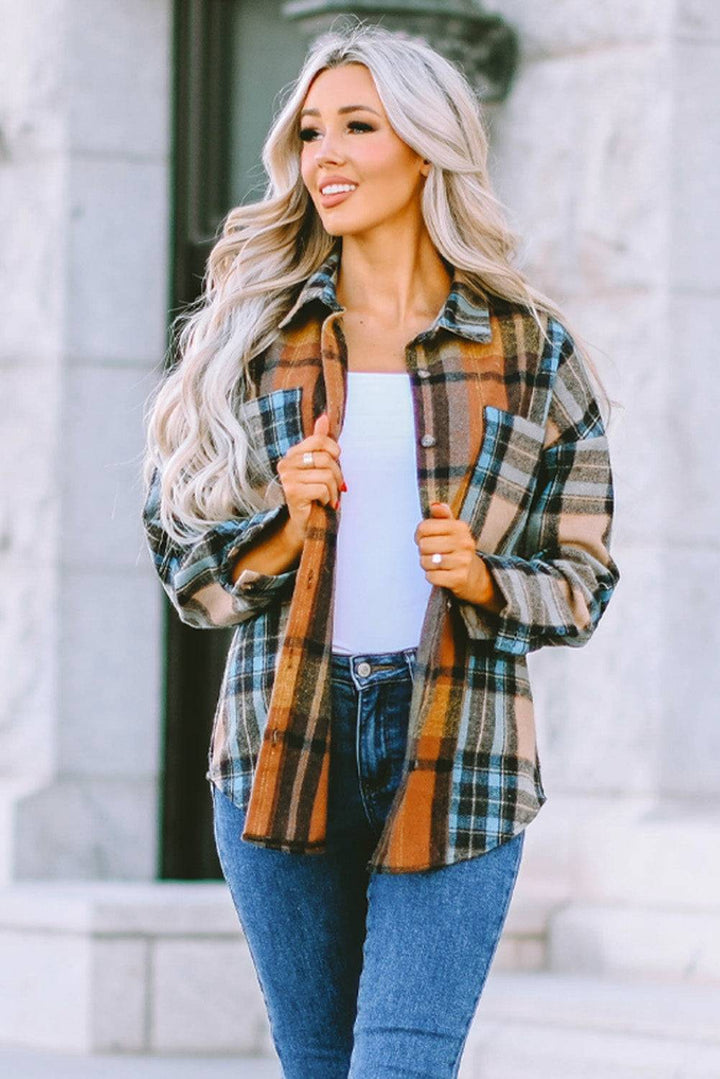 a woman wearing a plaid jacket and jeans