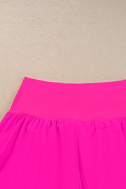 a bright pink skirt hanging up against a wall