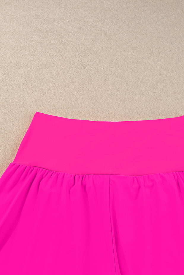 a bright pink skirt hanging up against a wall