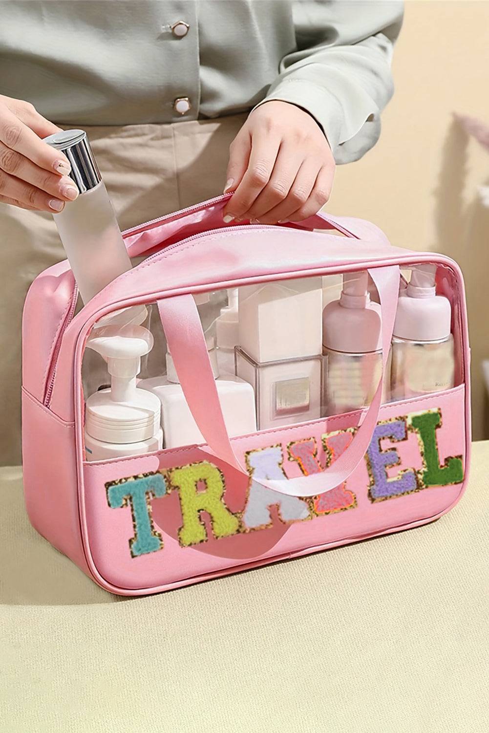 a person holding a pink travel bag filled with personal care items