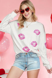 a woman wearing a white sweater with pink lipstick on it