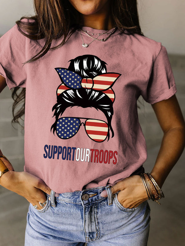 a woman wearing a pink shirt that says support our troops