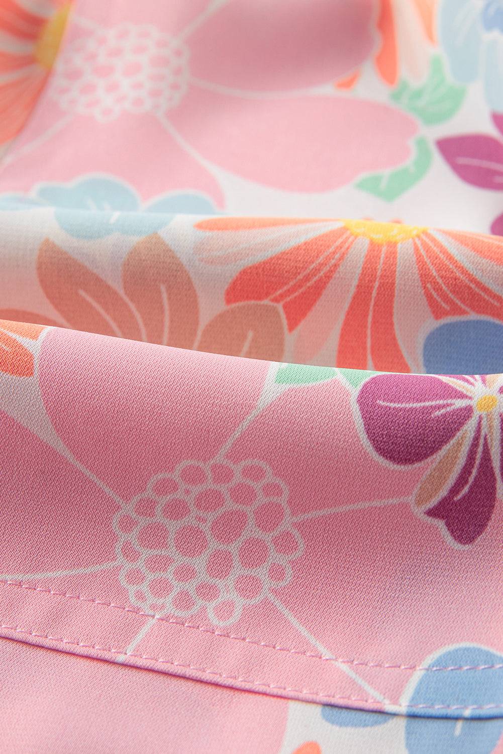 a close up of a pink flowered dress