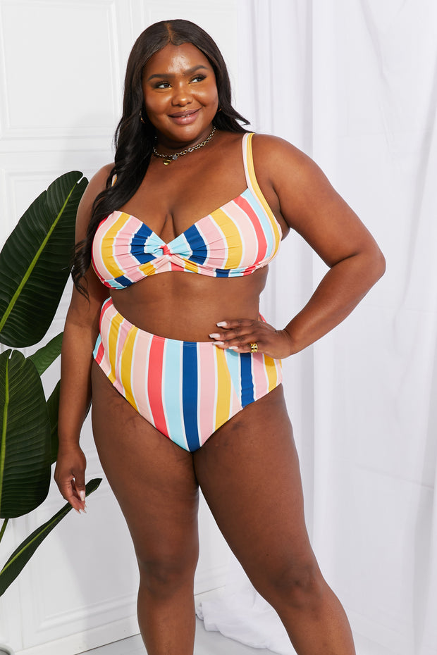 a woman in a multicolored bikini top and bottom