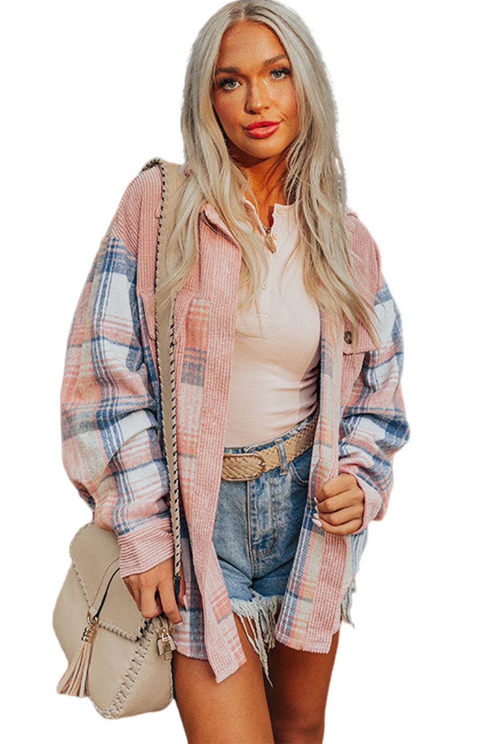 a woman wearing a plaid jacket and denim shorts