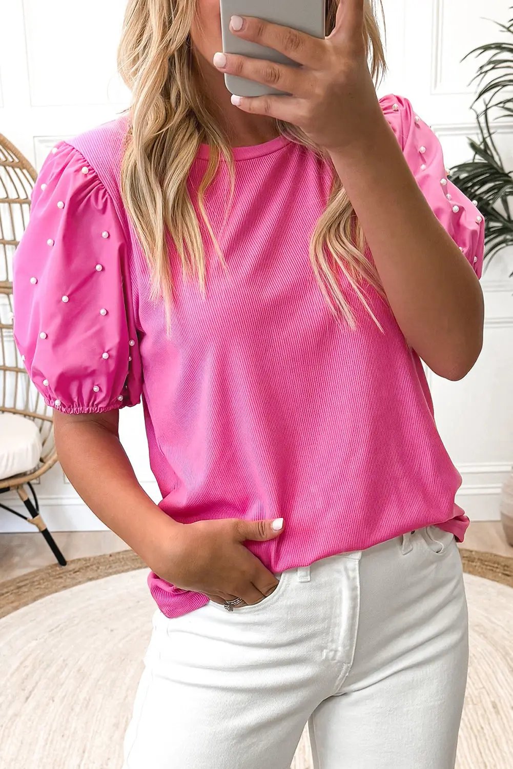 Front view of Bright Pink Ribbed Pearl Beaded Puff Sleeve Top paired with white jeans, showcasing ribbed fabric and pearl-embellished sleeves.
