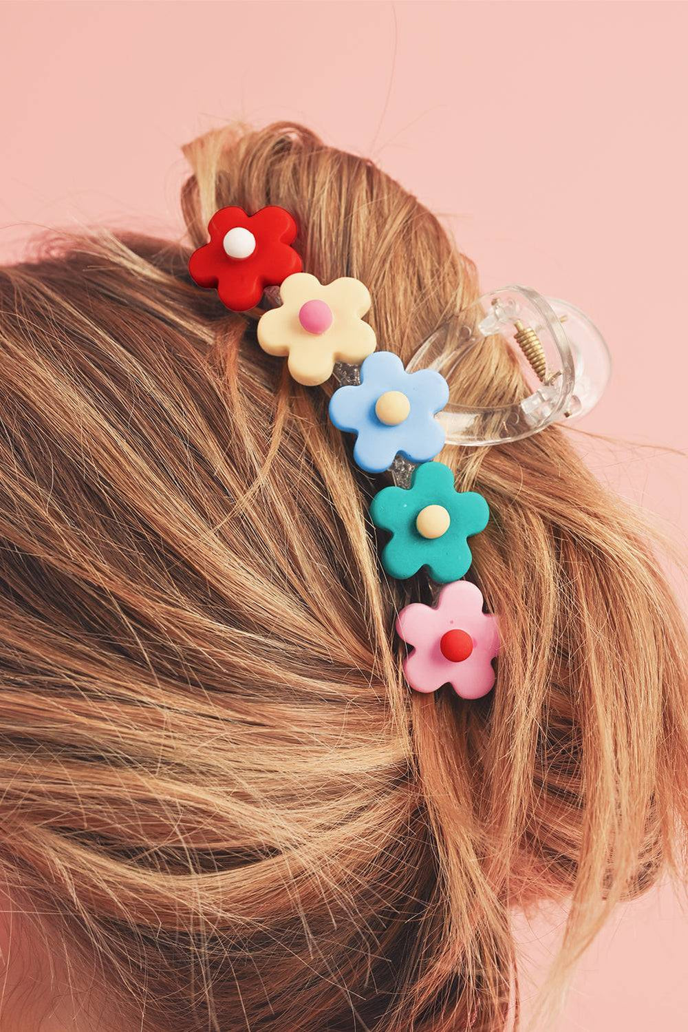 a close up of a woman's hair with flowers in it