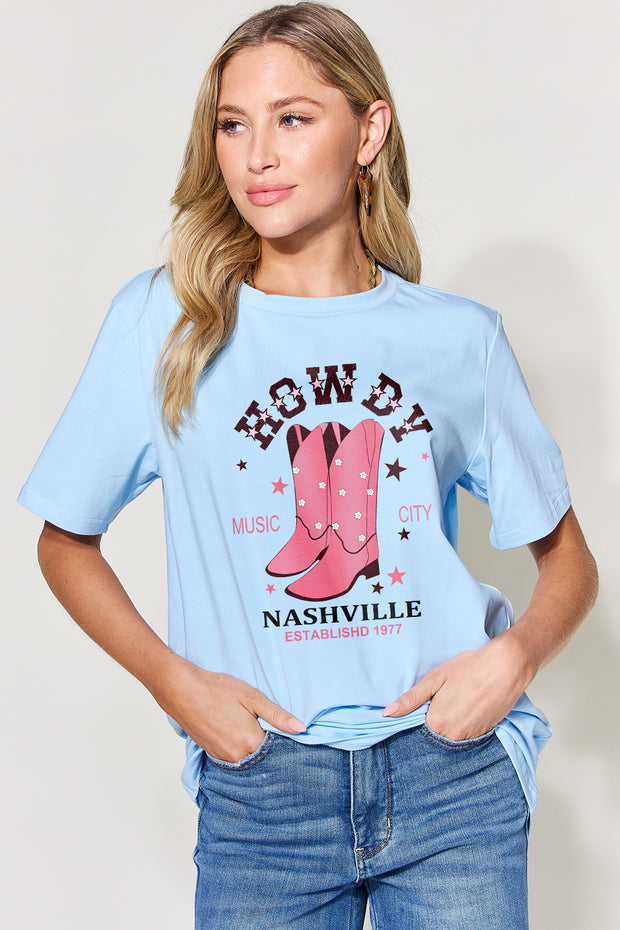 a woman wearing a blue shirt with a cowboy boot on it