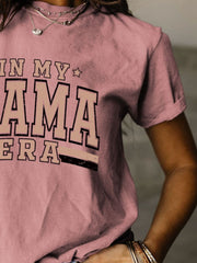 a woman wearing a pink shirt that says in my mama sierra