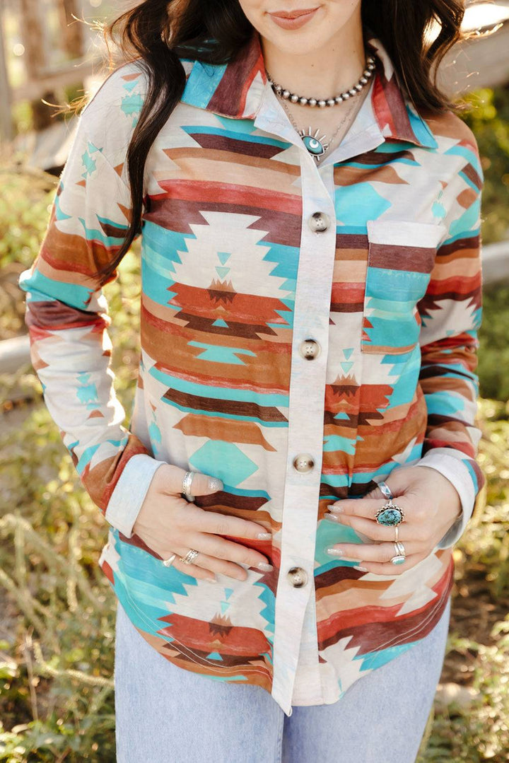 a woman wearing a hat and a colorful shirt