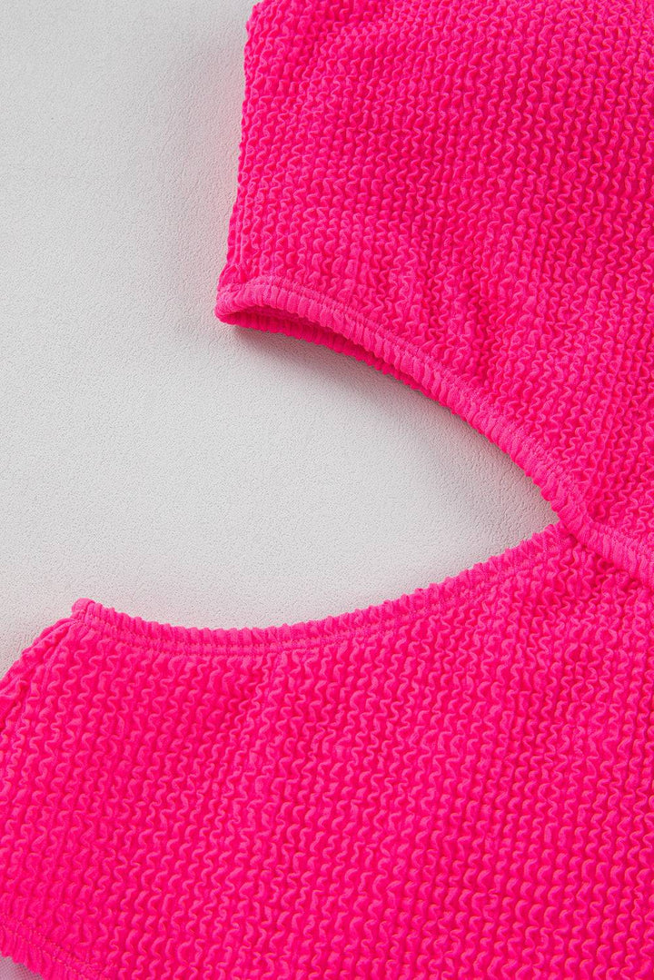 a close up of a pink sweater on a white surface