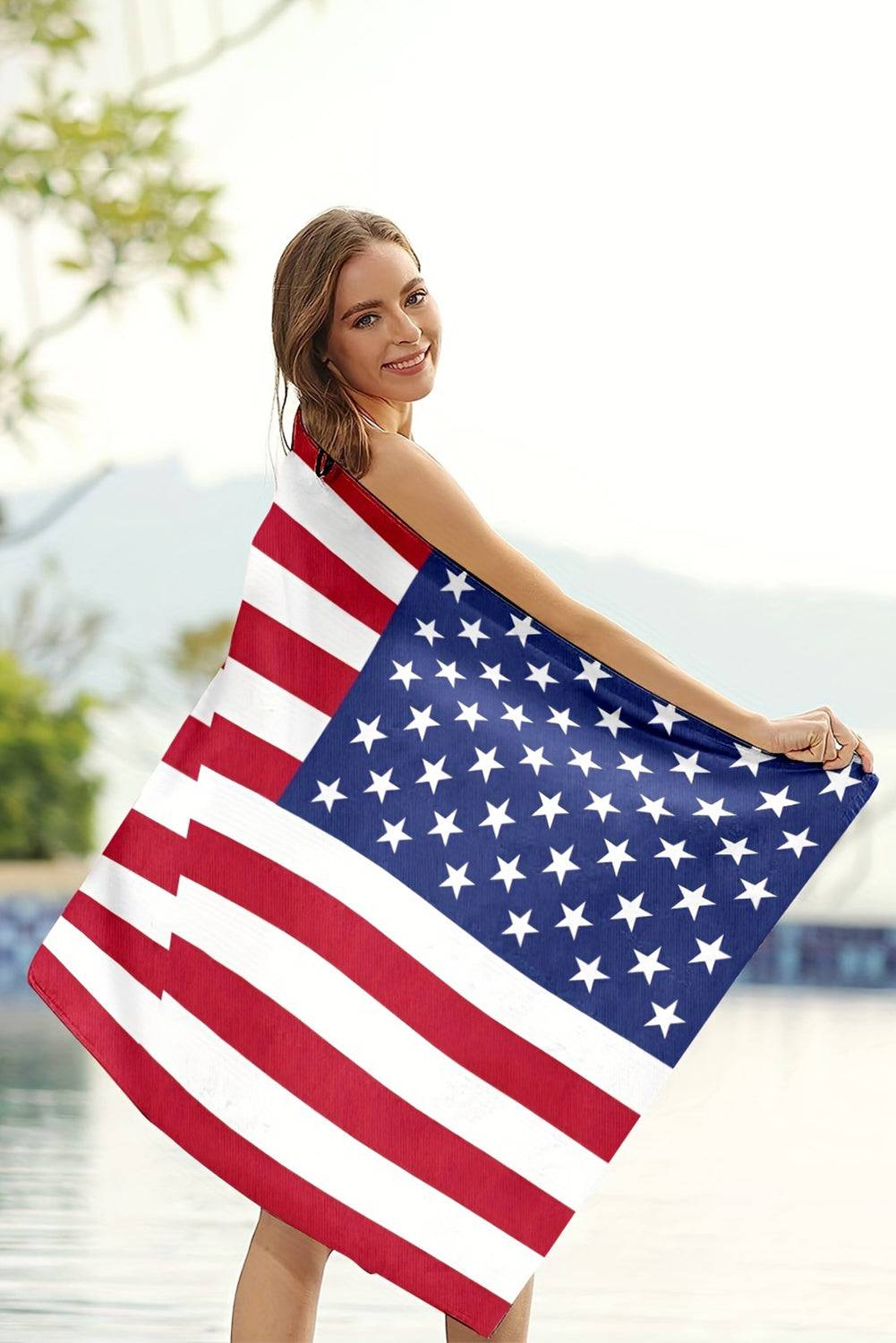 a woman is holding a large american flag